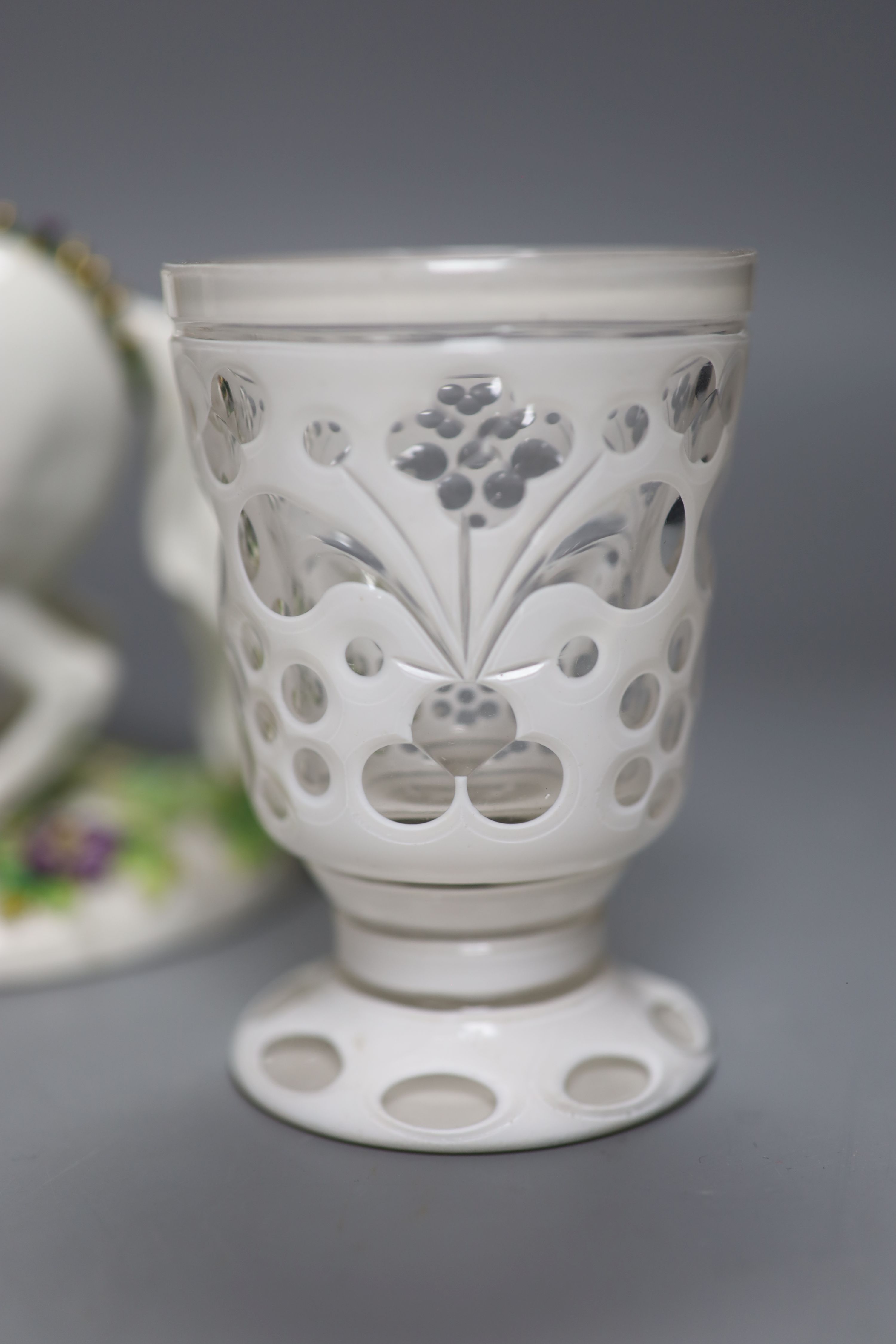 A Continental porcelain figure group, an overlaid glass goblet and a Royal Crown Derby miniature cup, tallest 20cm